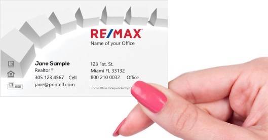 Hand holding business card -  ReMax homes business cards